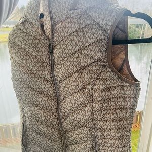 Packable coat with tags attached and Michael Kors letters